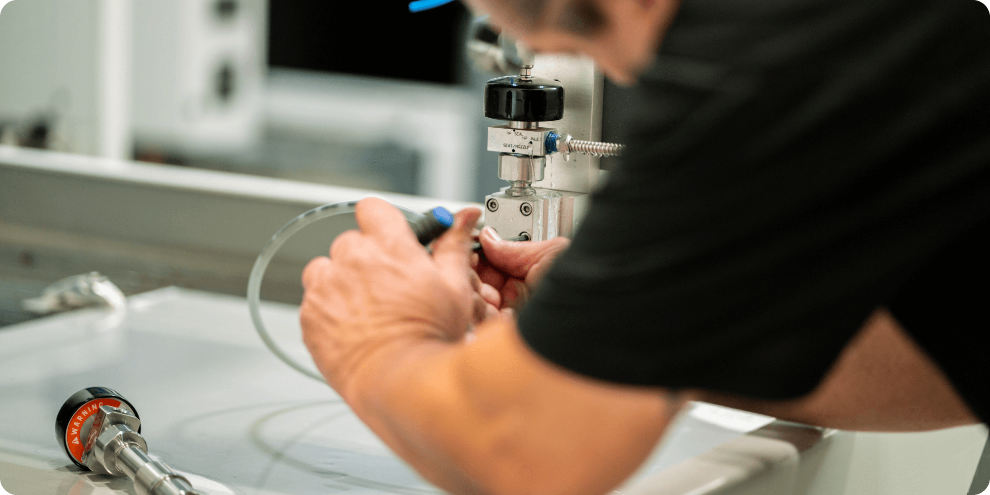 Flow employees working on a cutting head.