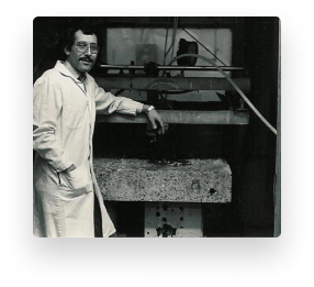 Dr. Mohamed Hashish standing with early abrasive waterjet