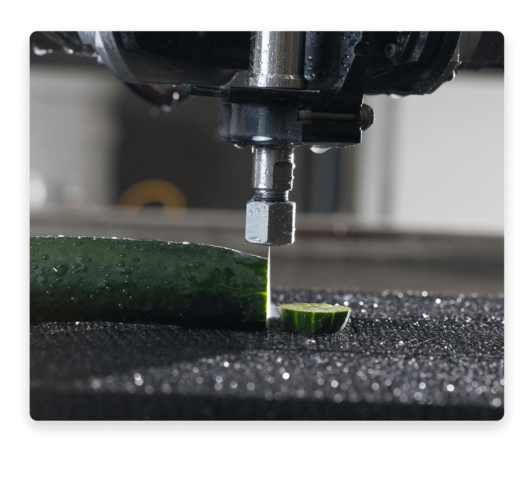 Water-only waterjet cutting head cutting a cucumber.
