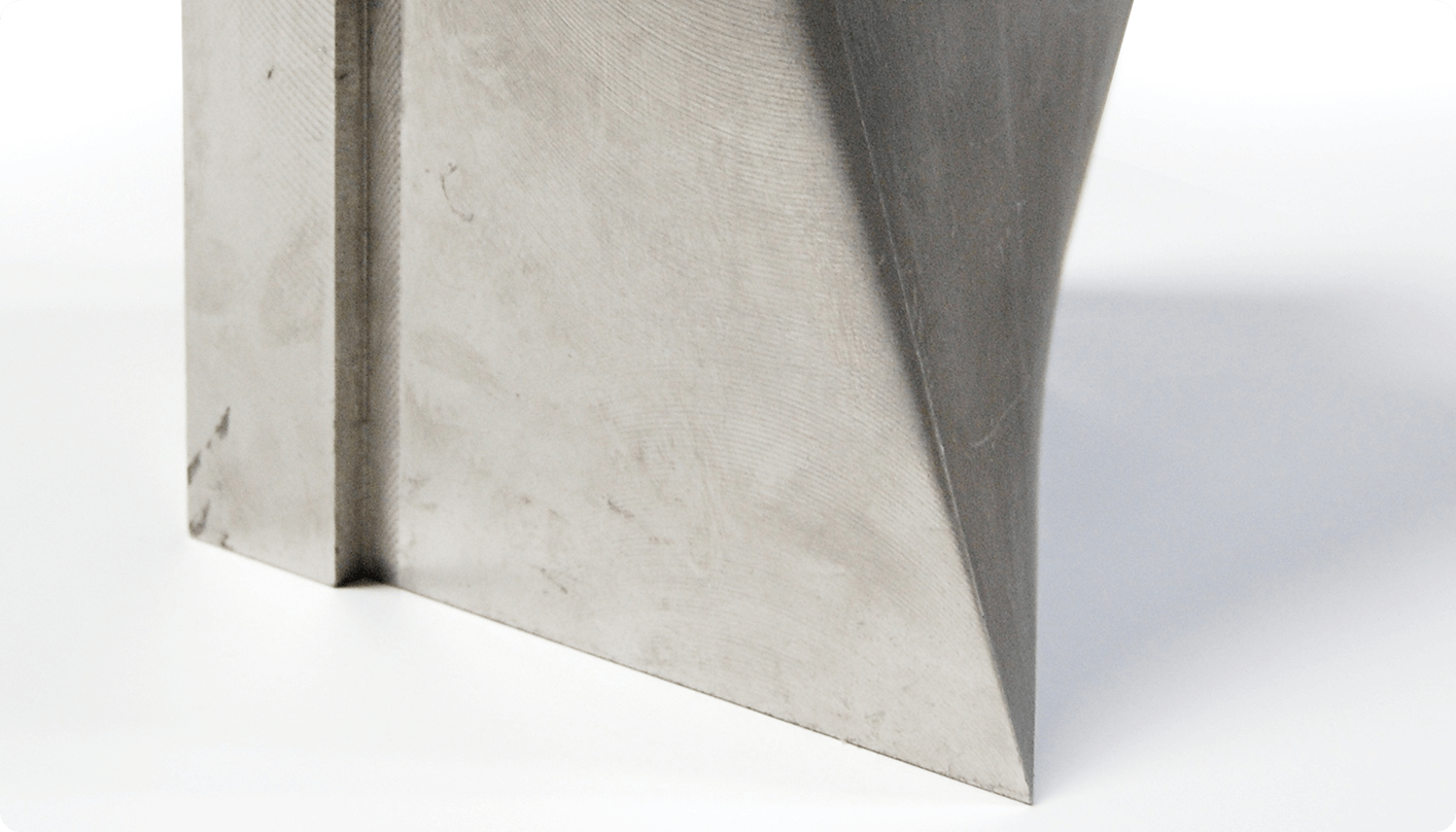 a thick steel block with smooth edges after cutting