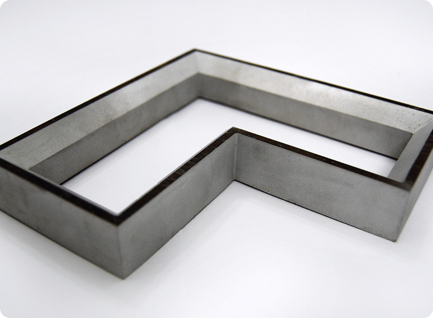 a metal cut part featuring an internal bevel cut with a straight exterior cut edge