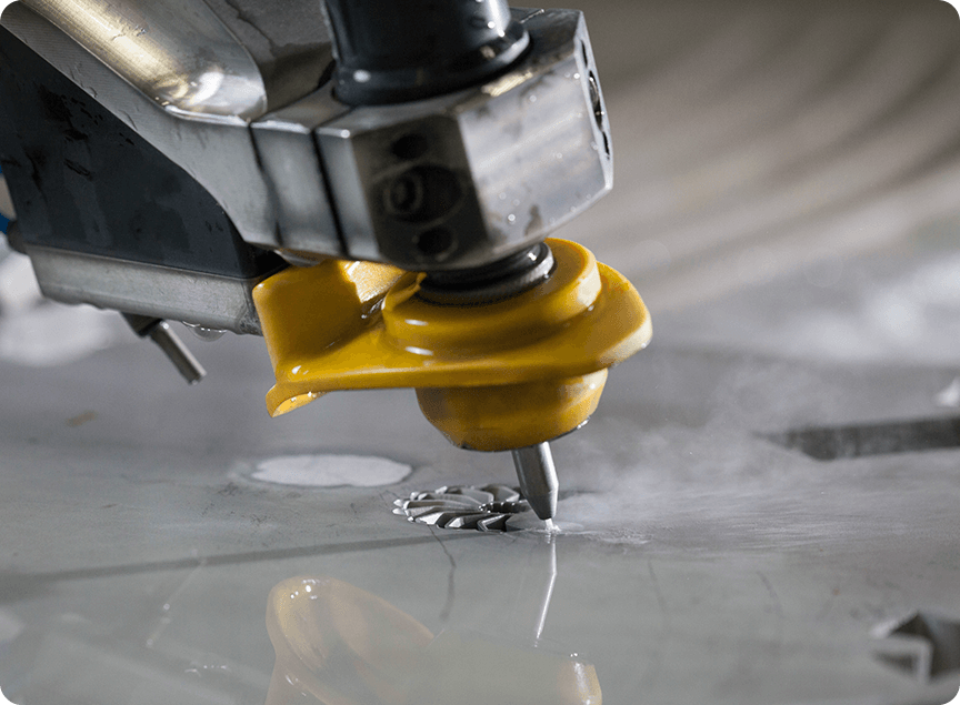 close up of a waterjet cutting a small metal impeller part